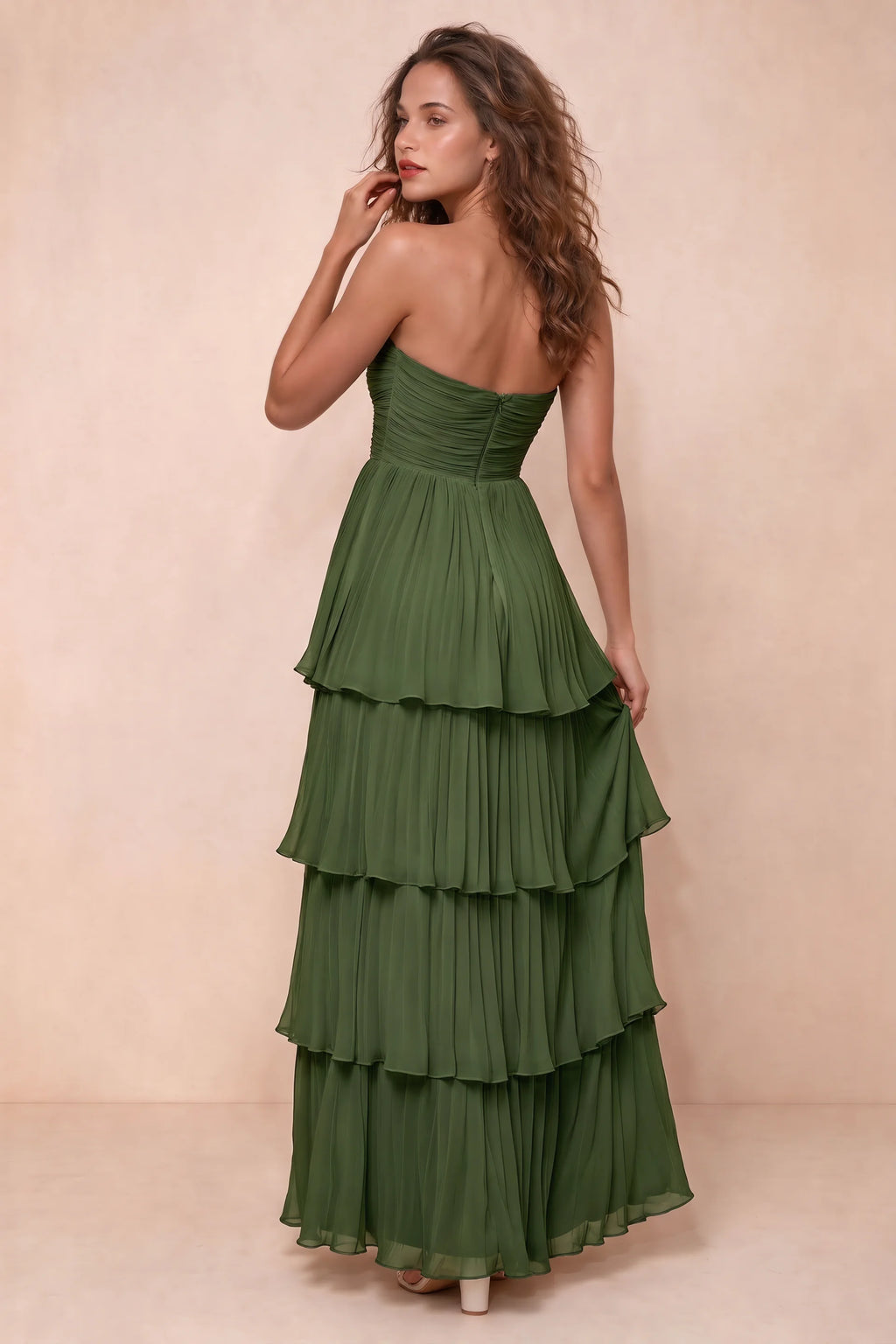 Rear studio view of Sonia olive green tiered pleated maxi dress with a long flowing skirt