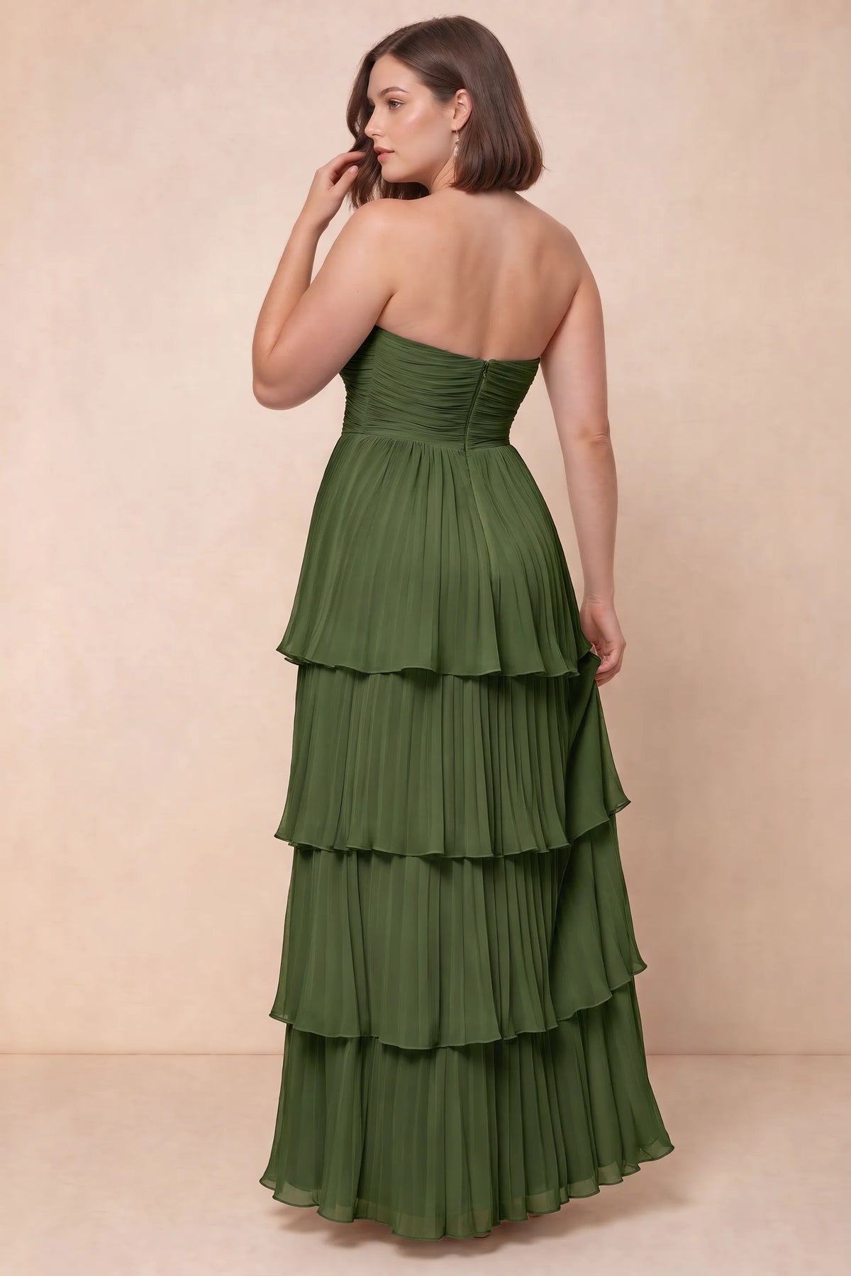 Rear view on a second model of Sonia olive green tiered pleated maxi dress with a long flowing skirt