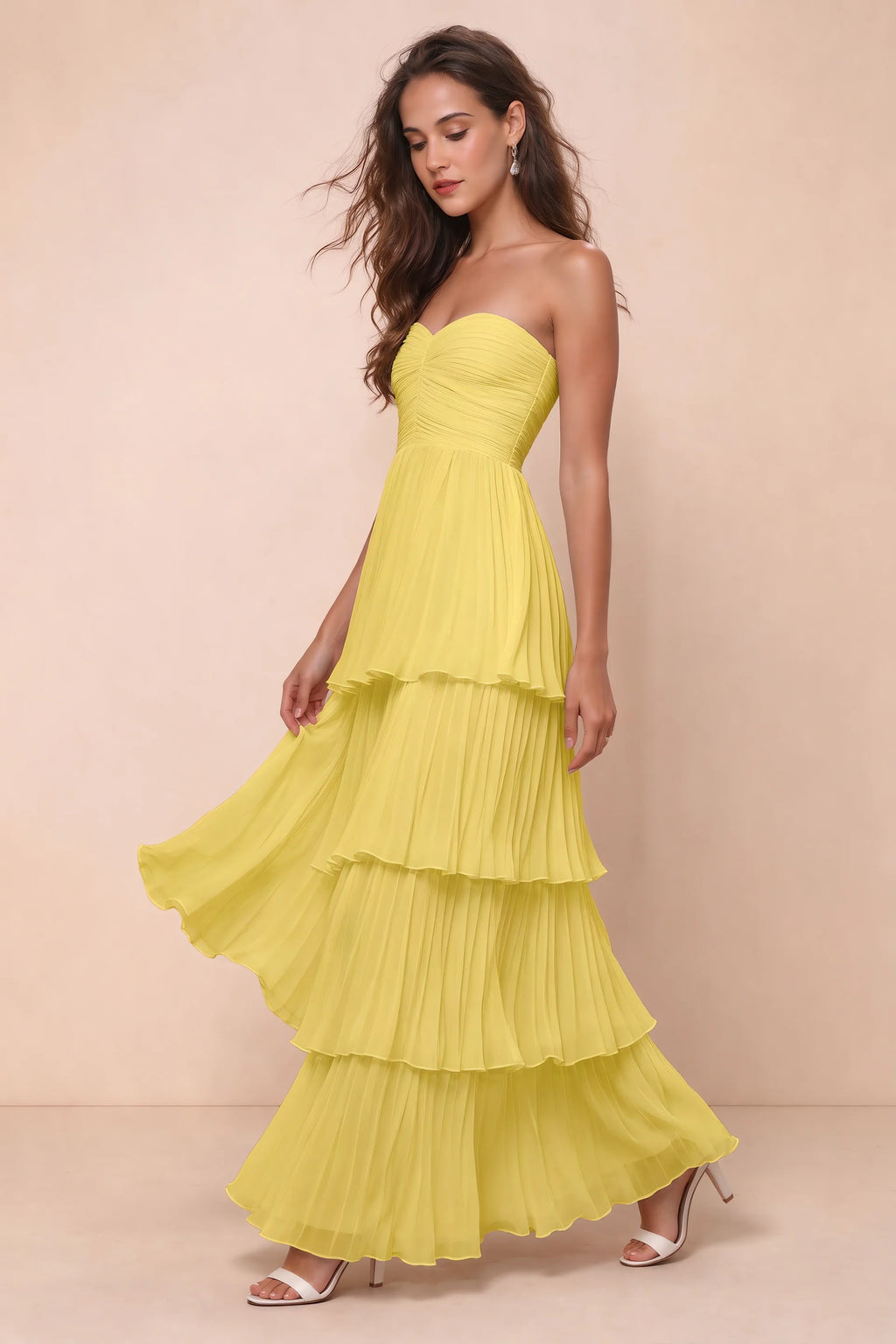 Front studio view of Sonia pastel yellow tiered pleated maxi dress with a long flowing skirt
