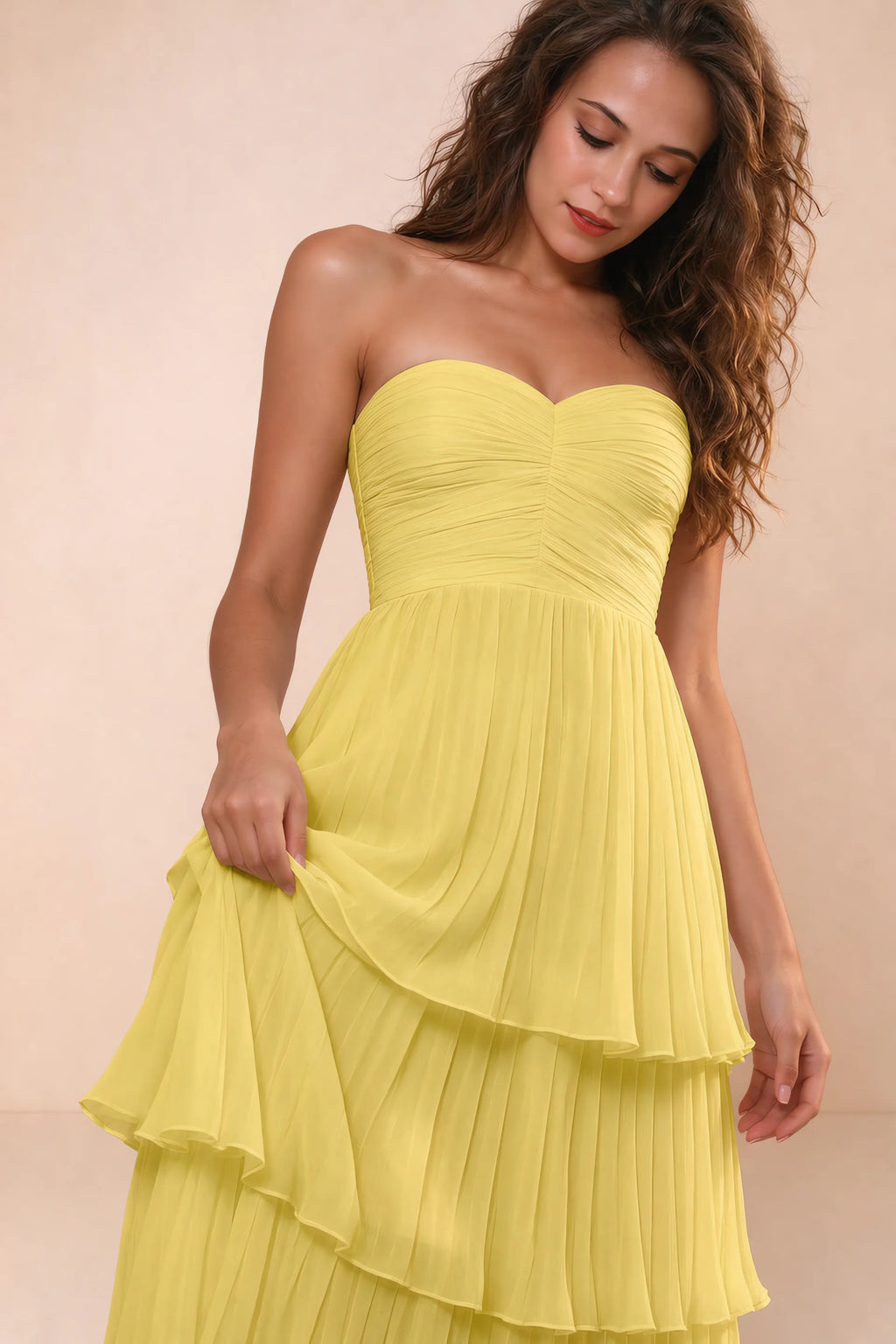 Close-up of strapless sweetheart neckline and ruched bodice of Sonia pastel yellow tiered pleated maxi dress