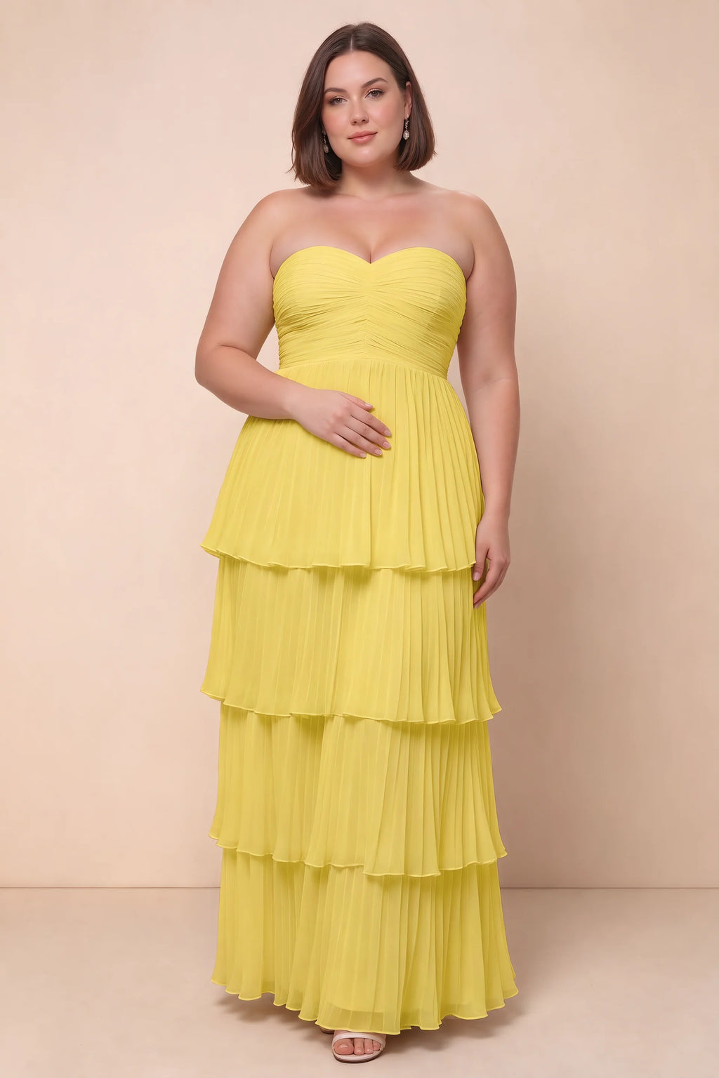 Front view on a second model of Sonia pastel yellow tiered pleated maxi dress with a long flowing skirt