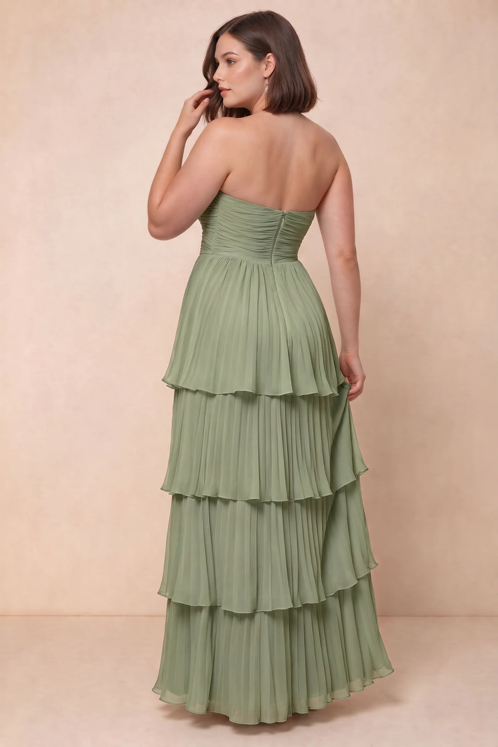 Rear view on a second model of Sonia pistachio tiered pleated maxi dress with a long flowing skirt