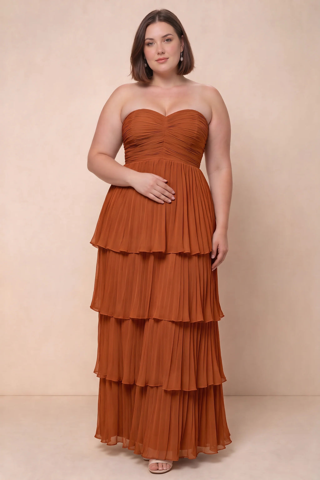 Front view on a second model of Sonia rust tiered pleated maxi dress with a long flowing skirt