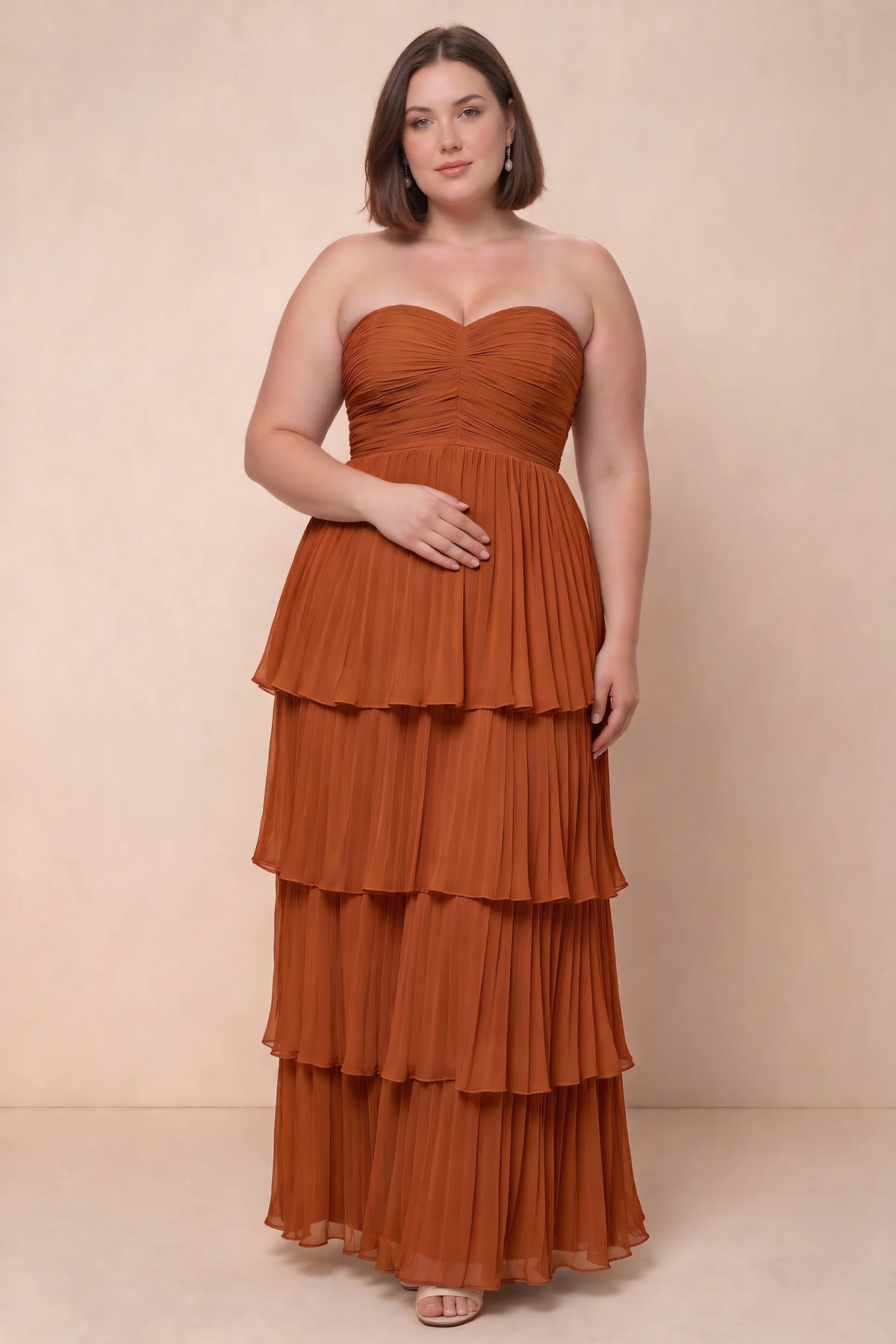 Front view on a second model of Sonia rust tiered pleated maxi dress with a long flowing skirt