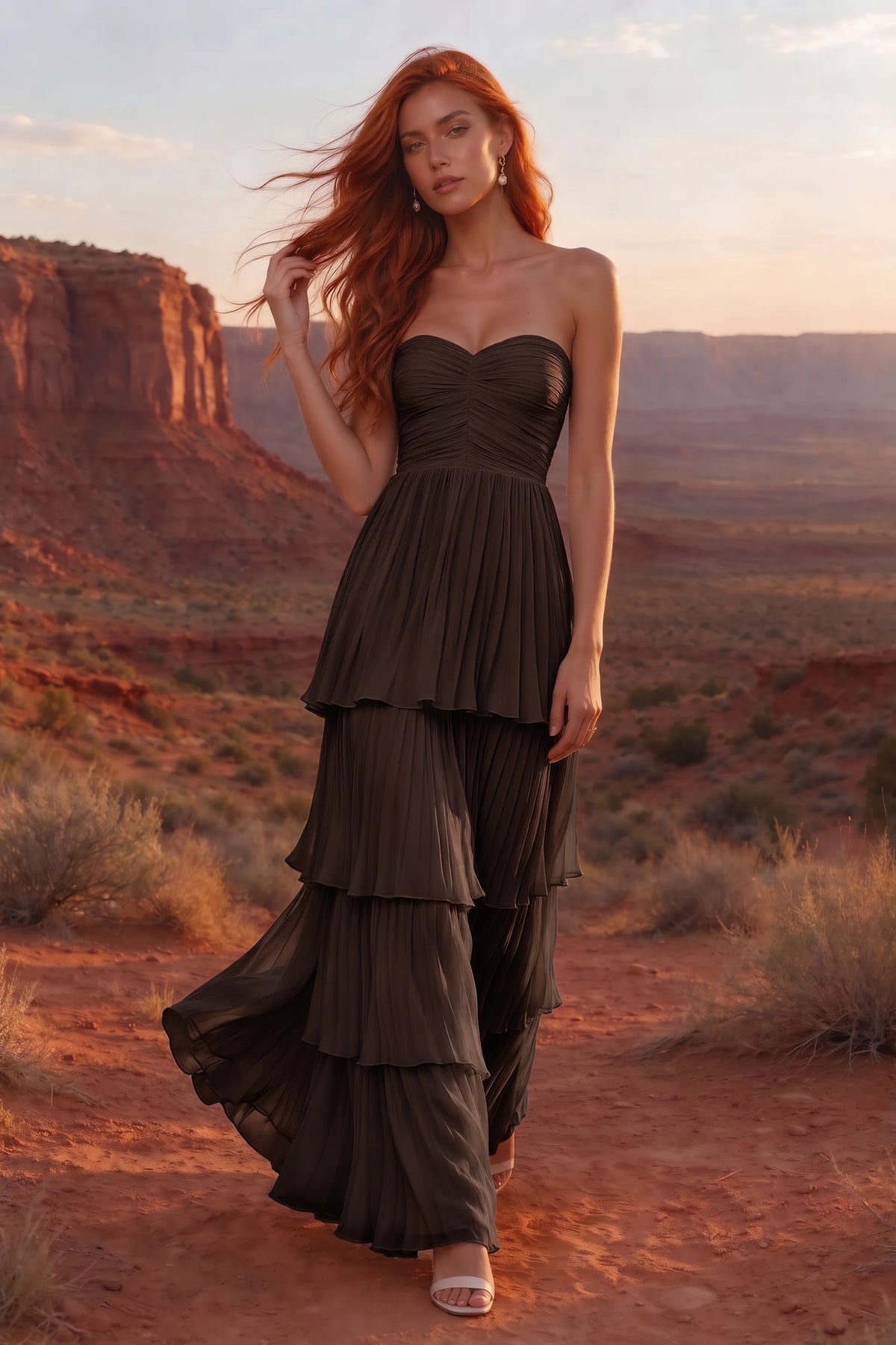 Outdoor front view in a desert canyon at sunset of Sonia truffle tiered pleated maxi dress with a long flowing skirt