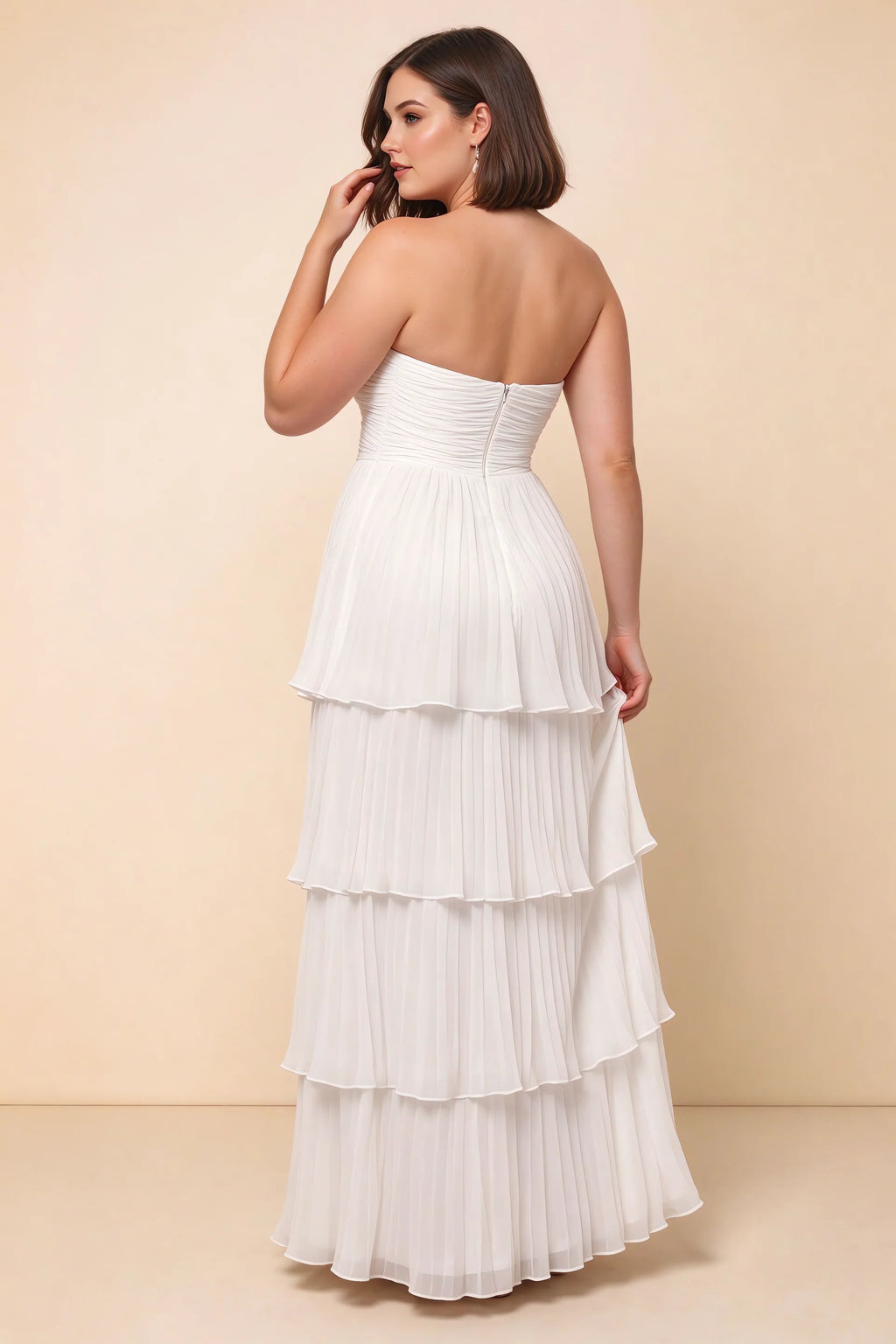 Rear view on a second model of Sonia white tiered pleated maxi dress with a long flowing skirt
