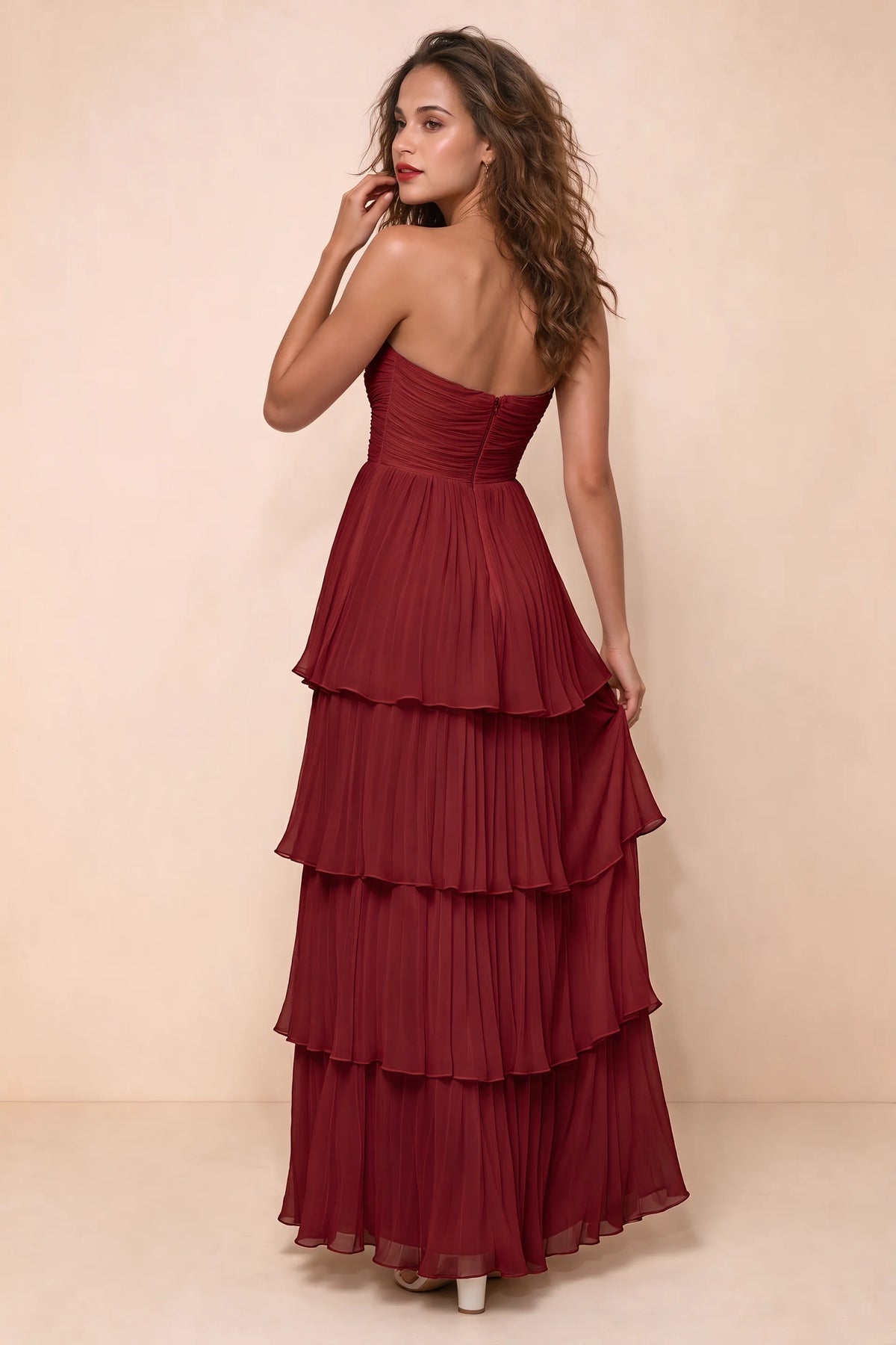 Rear studio view of Sonia wine tiered pleated maxi dress with a long flowing skirt