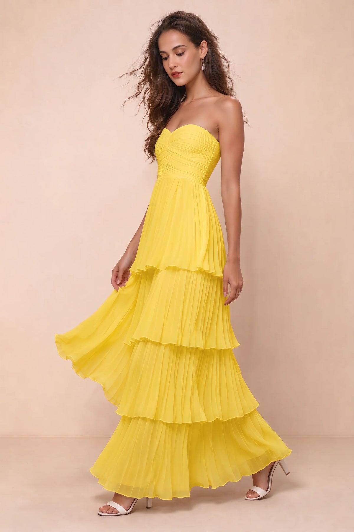 Front studio view of Sonia yellow tiered pleated maxi dress with a long flowing skirt
