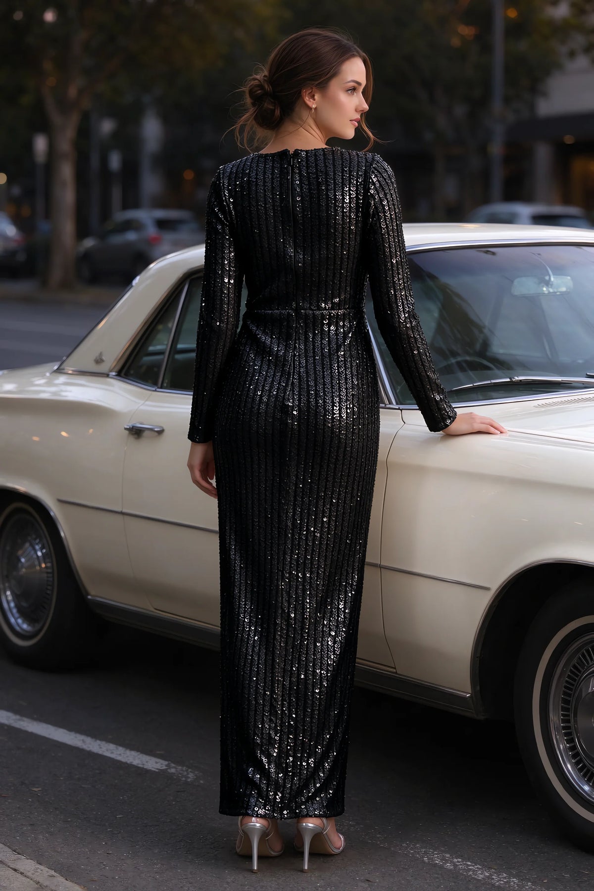 Outdoor rear view beside a classic car of Valeria black long sleeve V-neck slit maxi dress with a long straight skirt