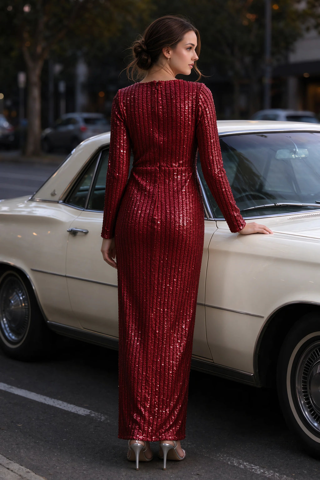 Outdoor rear view beside a classic car of Valeria burgundy long sleeve V-neck slit maxi dress with a long straight skirt