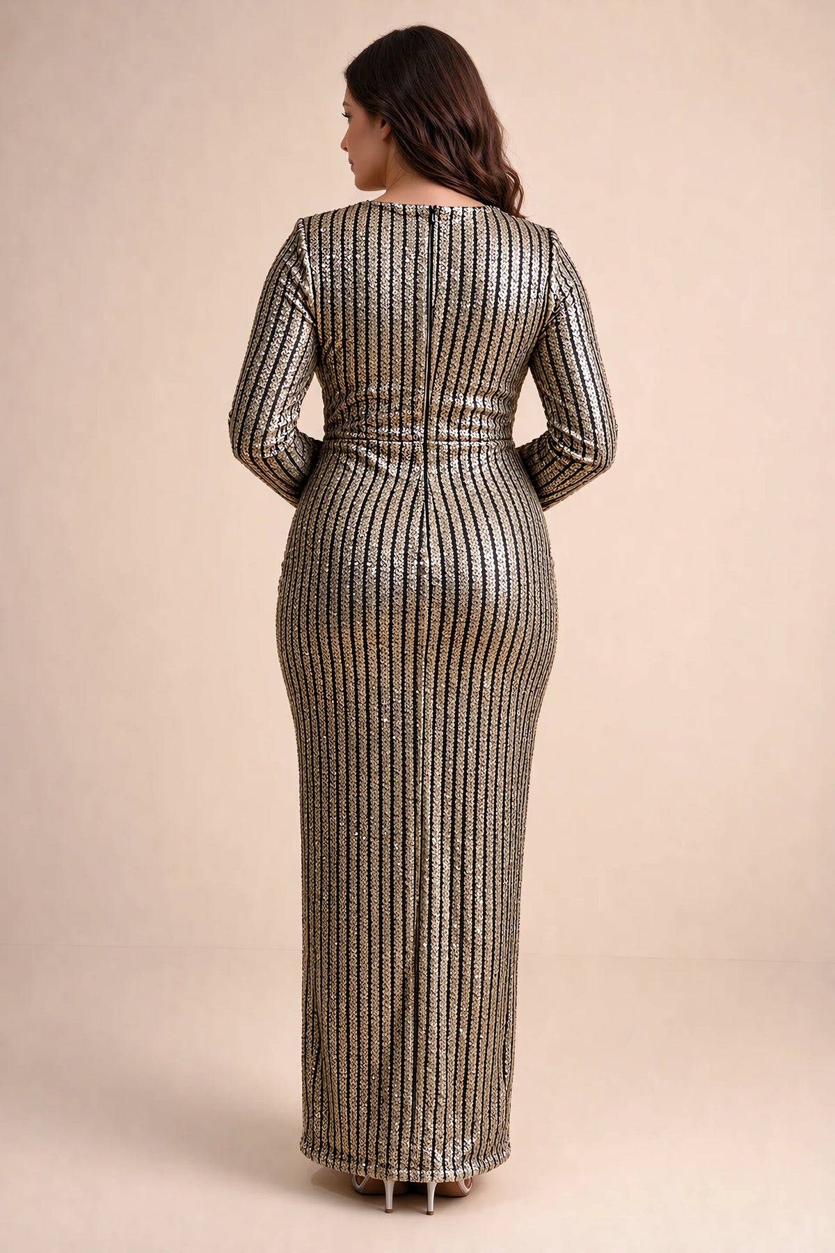 Rear view on a second model of Valeria gold long sleeve V-neck slit maxi dress with a long straight skirt